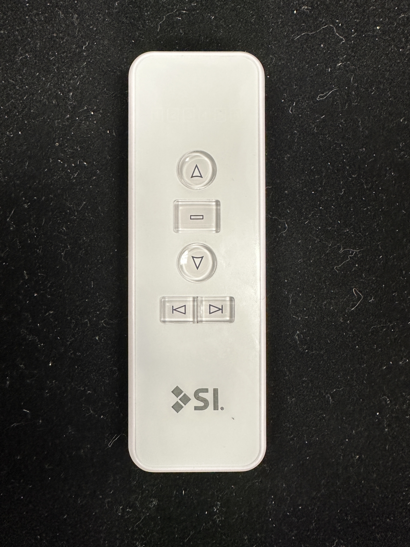 White SI KAOS remote with up, stop, down, and two side-scroll buttons