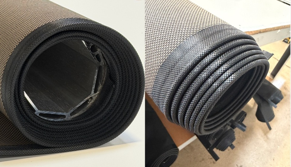 Rolled KAOS shade fabric showing internal motor tube cross-section and sewn side channel edge detail