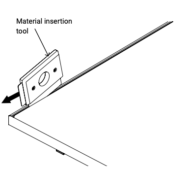 Material insertion tool sliding along the edge of a screen frame corner