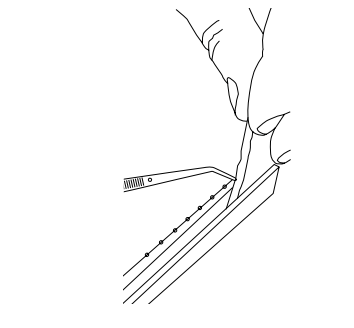 Hand pressing a small brush tool along the edge of a frame channel during assembly