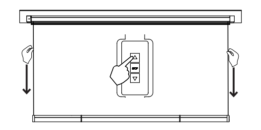 Hands steadying screen sides while finger presses wall switch down button to lower roll
