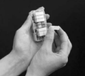 Hands holding and pressing buttons on a small cylindrical Decoset keypad device