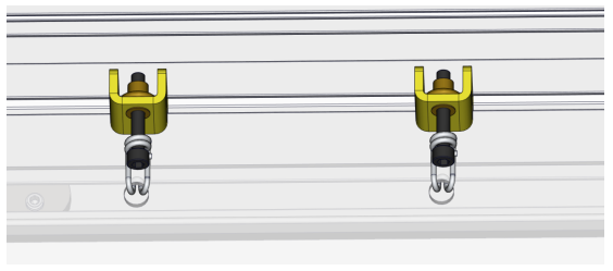 Two yellow tensioner brackets with bolts and carabiner hooks mounted along aluminum frame channel