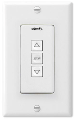 Somfy wall switch keypad with up, stop, and down buttons mounted on white wall plate