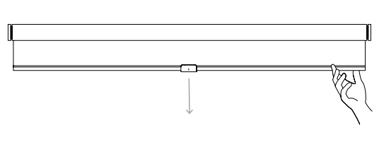 Hand pulling down on the bottom of a rolled shade to check fabric orientation and roll direction