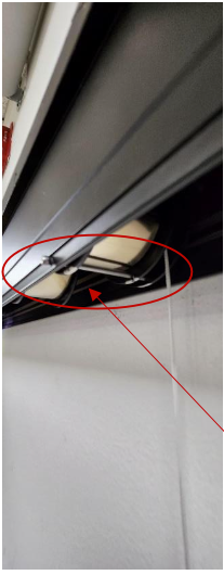Red circle and arrow highlighting tension cord attachment point on spring cassette hembar connection