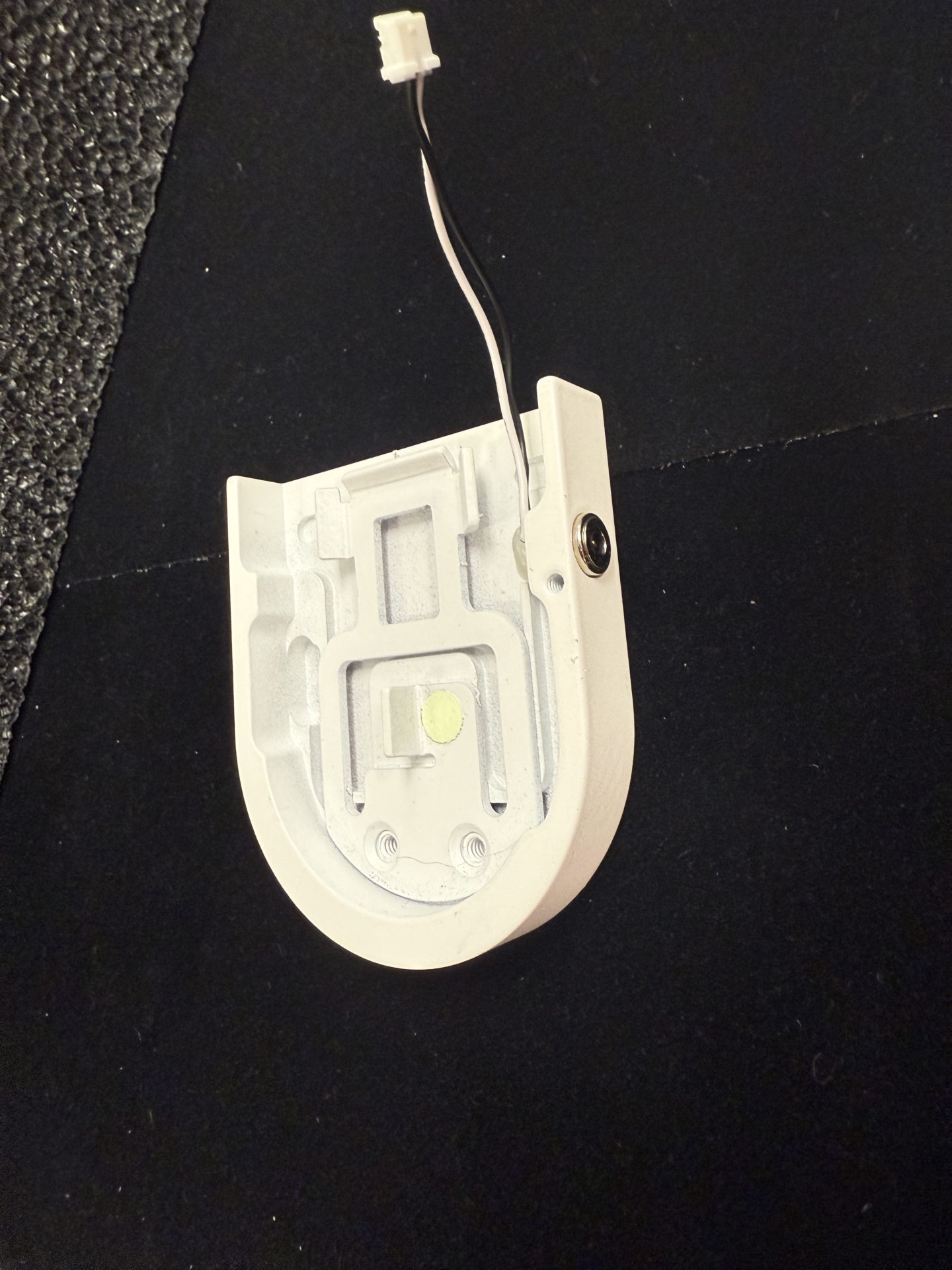 Tombstone end cap interior showing PCB board, LED, wiring harness, and side-mounted charging port button