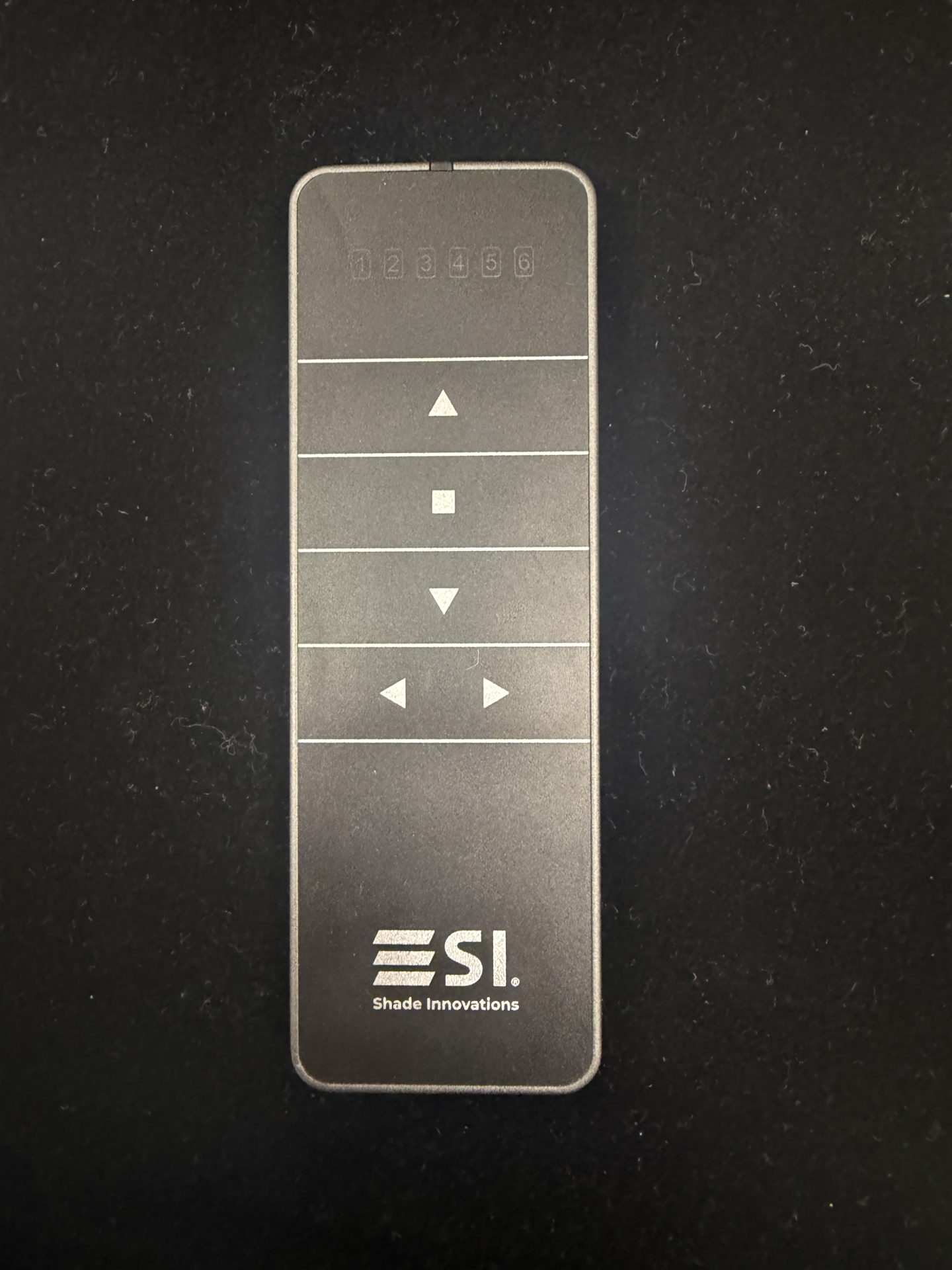 Screen Innovations Shade Innovations remote with six channel indicators and up, stop, down, and left-right arrow buttons
